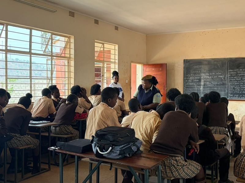 Pupils listening to a facilitator at the front of a classroom